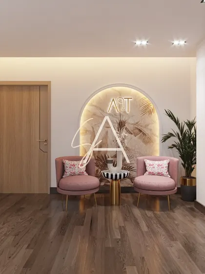 A small waiting nook within the clinic, featuring soft pink chairs and a decorative wall arch. These thoughtful details help create a comfortable and aesthetically pleasing experience for patients.