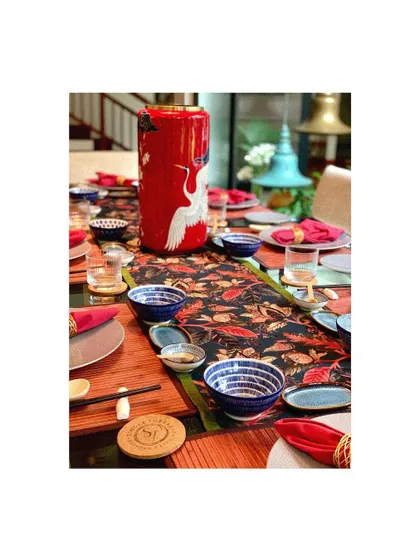 Another view of the colorful Asian-themed table setting, showcasing the mix of textures and patterns.