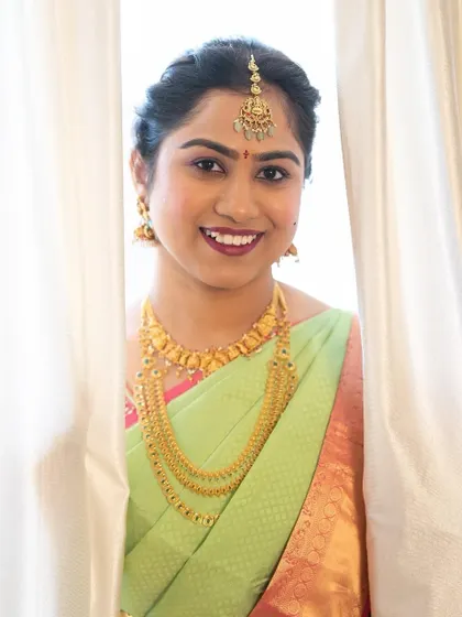 A peek at the beautiful bride. Her makeup is soft yet defined, with a lovely lip color that brings out the warmth in her smile and her traditional attire.