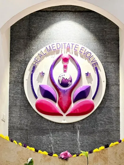 The 'Heal, Meditate, Evolve' emblem of Samyama, installed as a water feature at our Spiritual Centre. This beautiful installation represents the core of our mission and the continuous flow of spiritual energy.