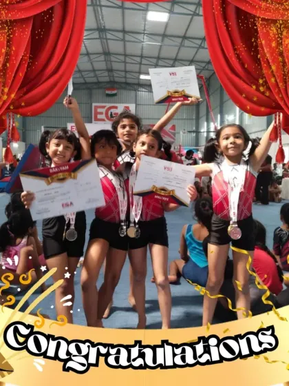 A team of our youngest female gymnasts celebrating their achievements together. The camaraderie and support they show each other is a core part of our academy's culture.