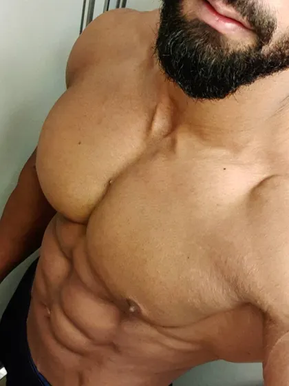 A close-up angle focusing on chest fullness and upper abdominal definition. This level of detail is what we aim for in competition prep.
