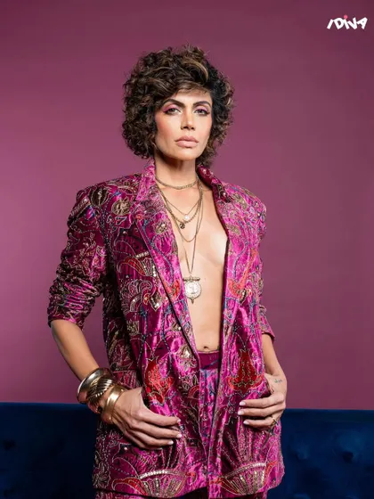 A close-up from the iDiva shoot with Mandira Bedi. The focus is on her powerful expression, complemented by the intricate details of the embroidered jacket.