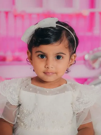 A classic portrait of our 2-year-old Barbie. Her bright eyes and sweet expression make this a truly timeless photo.