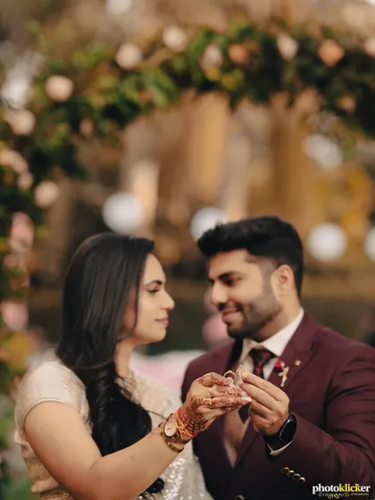A close-up of the couple holding their engagement rings together, symbolizing their new union. We focus on these significant details during your ring ceremony photography.