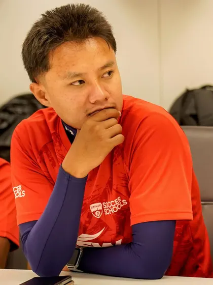 A coach in deep thought during a session on data analytics in football. We encourage continuous learning among our staff.