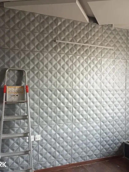 An installation of 3D foam panels in a geometric diamond pattern. These panels add significant depth and a modern, tactile finish to the wall, ideal for a contemporary home.