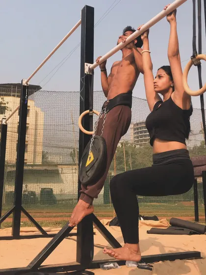 Stronger together. This couple pushes each other to new heights with partner-assisted and weighted workouts.