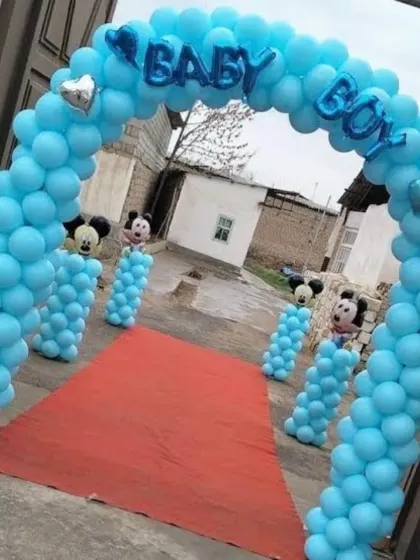 A blue balloon arch with "BABY BOY" foil balloons and Mickey Mouse details, perfect for a birthday or welcome home party.