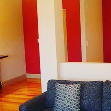 Using bold red stripes as accent walls to break up a neutral space. This color-blocking technique is a simple way to add energy and define different zones in a room.