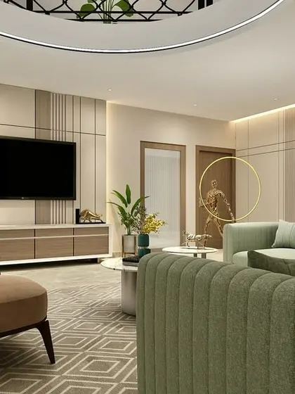 In this harmonious living room, we used custom sofas in a muted sage green to introduce a soft, natural color. The furniture is arranged to create a comfortable and balanced space, complemented by warm wood tones and geometric patterns on the rug.