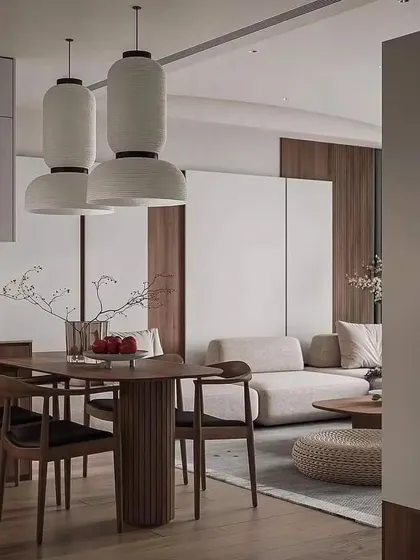 An open-plan layout connecting the dining area to the living room, featuring Japanese-style lantern pendant lights over the dining table.