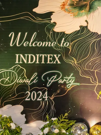 A close-up of the welcome signage for the Inditex Diwali Party 2024. The elegant typography and line art on a deep green background set a sophisticated tone for the corporate celebration.