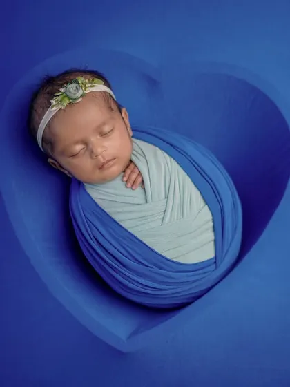Sleeping soundly, dreaming big. This simple, classic swaddle pose is perfect for capturing the peacefulness of a newborn.