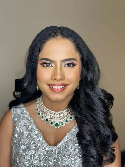 A happy, smiling bride. The makeup is designed to enhance her joy, with a focus on radiant skin and eyes that sparkle.