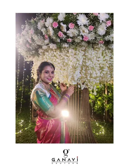 Our client Lavanya looks beautiful in her custom hand-embroidered blouse, posing against a backdrop of festive lights and flowers. Her look is a perfect example of authentic and effortless elegance.