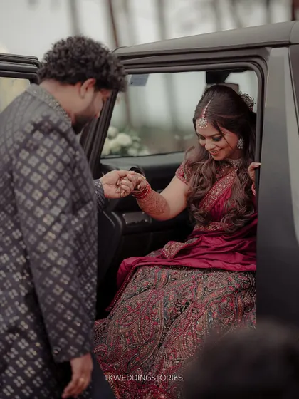 A candid moment of a groom helping his bride out of the car upon arrival at the reception venue. A small gesture of love and care.
