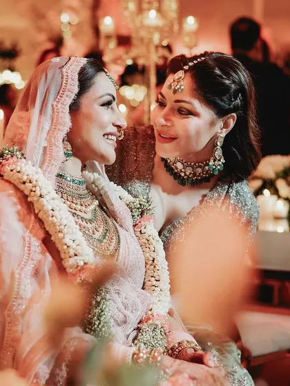 A touching moment between the bride and a loved one, sharing a hug and a smile during the ceremony.