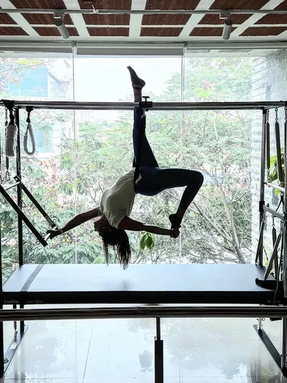 This is a beautiful expression of strength and flexibility on the Cadillac. The 'Spread Eagle' pose opens the hips and chest while requiring significant core and upper body strength to hold the position.
