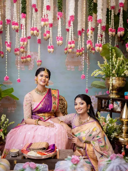 A quiet moment of connection between the bride and a loved one. The traditional setting, with its soft colors and fragrant flowers, enhances the emotional depth of the occasion.
