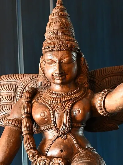 A close-up of a wooden deity, showcasing the intricate carving and expressive features. This piece was a highlight of our Navaratri open house, reflecting the cultural grace and detailed craftsmanship I curate.