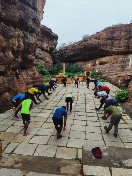 Participants stretch and warm up on the ancient stone pathways of Badami.