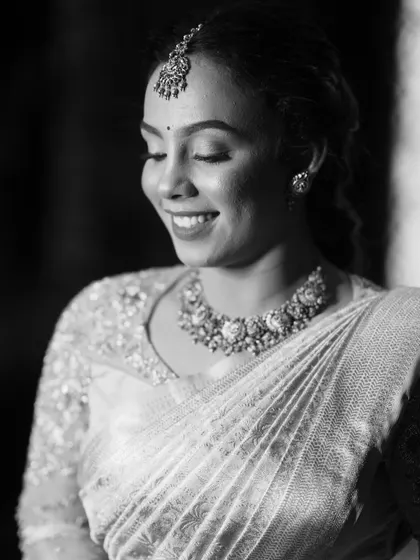 A black and white portrait that emphasizes the texture and detail of the embroidery, creating a timeless and classic image.