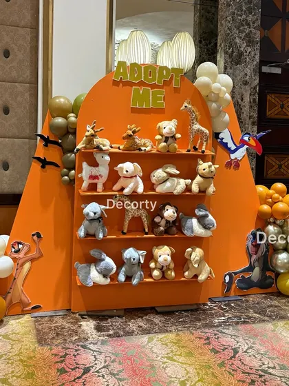 A closer look at the 'Adopt Me' party favor station, filled with a variety of jungle-themed stuffed animals for the kids to choose from.