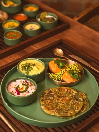 A slightly different angle of the modern Indian platter, showing the depth and layering of the trays. This perspective is useful for showcasing unique serving ware.
