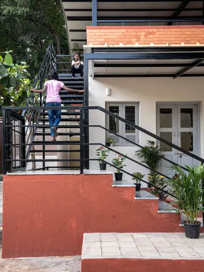 The staircase was designed to be more than just a way to get to the upper level. The wide, granite-lined concrete steps double as informal seating, and the space underneath is cleverly used for storage, making every part of the structure functional.