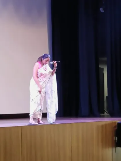 On stage at Greenwood High, I'm demonstrating how to stand correctly to distribute body weight, a crucial tip for teachers who are on their feet for many hours. Practical advice is at the core of my talks.