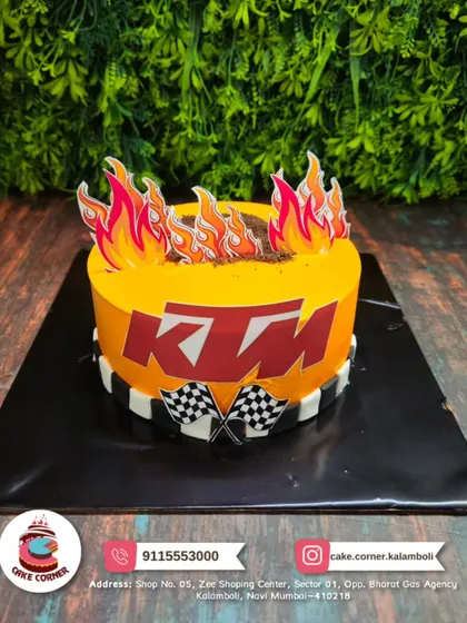 Ready to race! A fiery KTM bike-themed cake. The orange colour, flames, and checkered flags make it perfect for a biking enthusiast.