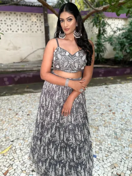 A full-length view of the client in the grey Indo-Western lehenga.