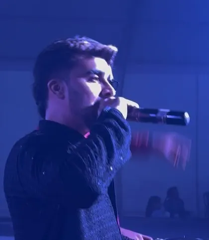 On the mic during a Dandiya Mahotsav, engaging with a crowd of over 10,000 people. I'm experienced in hosting and DJing for large-scale concerts and festivals.