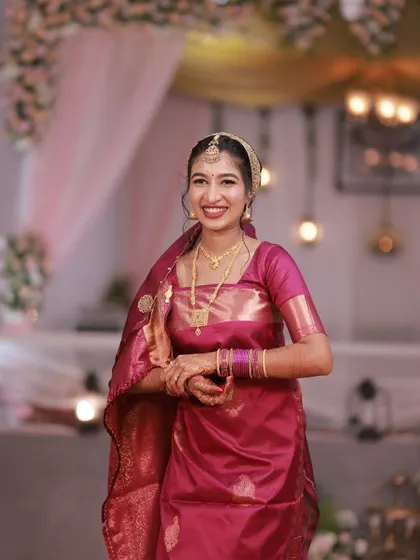 A happy, smiling portrait of a bride for her Oorkuduva ceremony. Her makeup is fresh and natural.