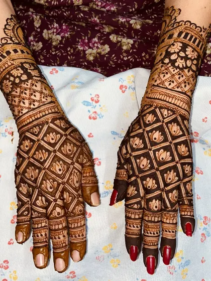 A striking design with a bold checkerboard pattern filled with lotus motifs, covering the entire hand for a full and impactful look.
