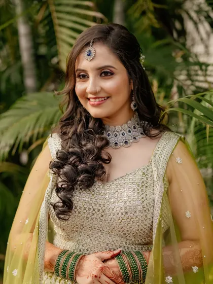 Sheetal looking radiant for her sangeet. The soft curls and glowing makeup are perfect for dancing the night away.