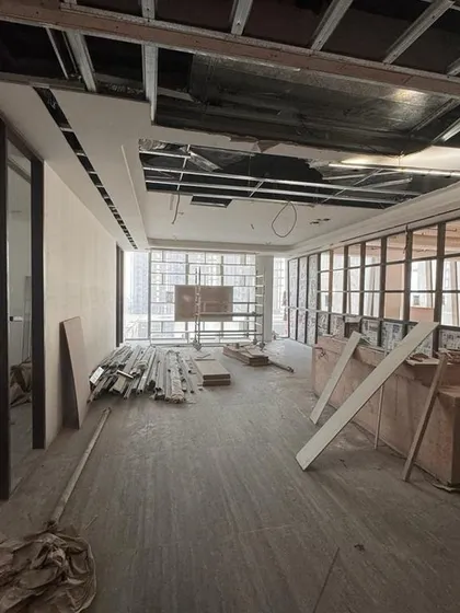 This image from the Carlsberg site shows the installation of glass partitions and the ceiling grid. This phase is crucial for defining different zones while maintaining a sense of openness and light throughout the office.
