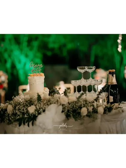 The cake and champagne table is adorned with clouds of baby's breath, continuing the soft white theme of the wedding.