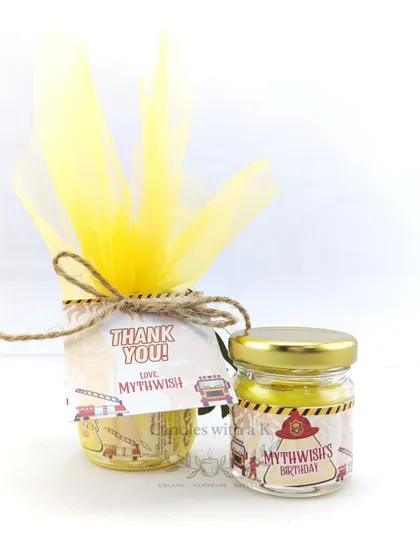 Another view of the packaged fire truck candle, a perfect, memorable gift for young guests.