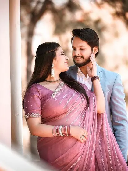 A tender moment from a pre-wedding shoot in the hills. The bride-to-be gently touches her partner's cheek, a simple, loving gesture that makes for a beautiful and emotional portrait.