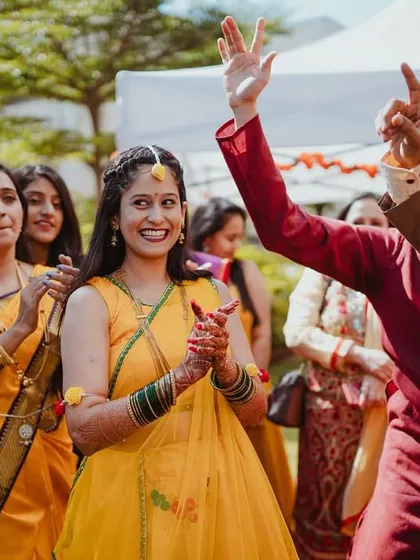 The bride's grand entrance to the Haldi ceremony, full of smiles and energy.