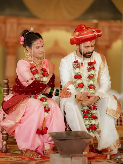 The couple seated for their wedding rituals. This shot captures the solemnity and tradition of a Maharashtrian wedding ceremony.