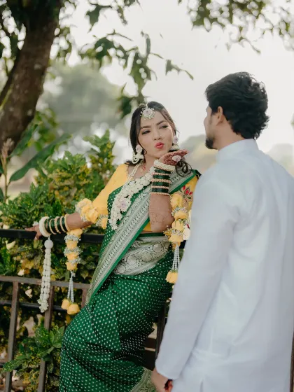 A playful moment between the couple during their Haldi ceremony. The bride blowing a kiss to her groom is a perfect candid shot, full of fun and love.