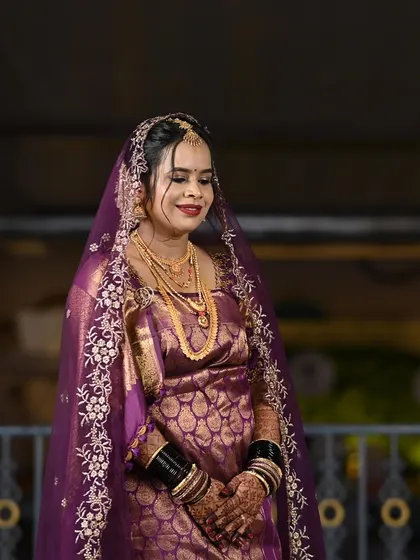 A smiling portrait of the bride. Her makeup is flawless, and she looks happy and confident.