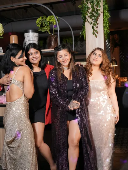 A group of friends shining in sequins and smiles at our CalOn party. The dress code was on point.