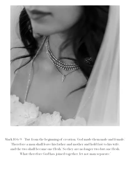 A close-up of the bride's necklace, with a biblical verse below. This black and white image beautifully connects the bride's faith with the fine details of her attire.