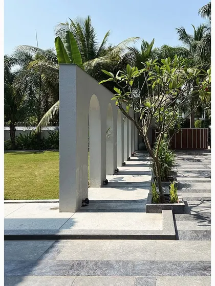 The strong architectural form of the arched wall at the Tropical Manor contrasts with the soft, organic shapes of the lawn and trees. This balance between structured and natural elements is a core part of my landscape architecture philosophy.