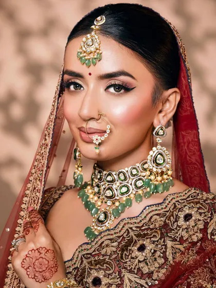 A beautiful bridal close-up focusing on the sharp winged eyeliner and the intricate details of the nose ring and polki necklace.