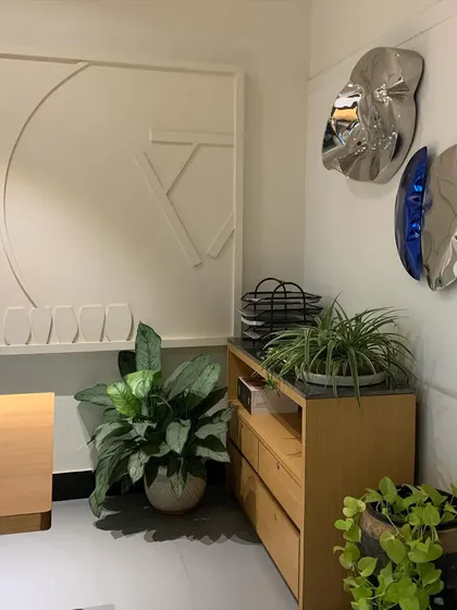 This corner of my office features an abstract wall treatment and metallic art pieces. The wall was originally uneven, so instead of leveling it, I chose to embrace its imperfection and turn it into a unique, seamless feature.